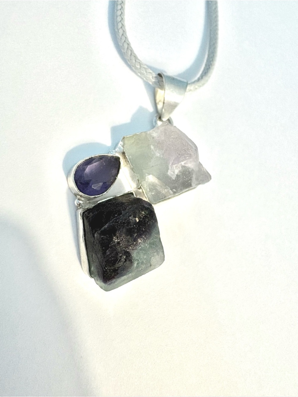 1 1/2 inch, rough, raw, Fluorite and Amethyst pendant on a grey leather chain.